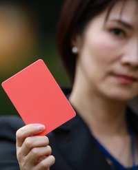 A woman holding a red card